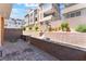 Landscaped backyard area featuring brick walls, terraced levels, and lush greenery, offering a private outdoor space at 647 Spotted Falcon St, Las Vegas, NV 89138