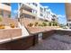 Multi-level home with landscaped terraces, brick retaining walls, and gated access to the upper levels at 647 Spotted Falcon St, Las Vegas, NV 89138