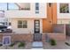 Contemporary home exterior with a small front yard, modern door, and a combination of stone and stucco finishes at 647 Spotted Falcon St, Las Vegas, NV 89138