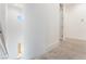 Light-filled hallway with carpet and tall ceilings. A view down from an upper floor at 647 Spotted Falcon St, Las Vegas, NV 89138