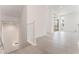 Open hallway with tile flooring, leading to a living space with large windows, offering ample natural light at 647 Spotted Falcon St, Las Vegas, NV 89138