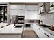Bright kitchen features stainless appliances, marble countertops and backsplash, and sleek white cabinetry at 647 Spotted Falcon St, Las Vegas, NV 89138