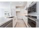 A view of the new kitchen with white cabinets, a kitchen island, and stainless steel appliances at 647 Spotted Falcon St, Las Vegas, NV 89138