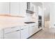Close-up of the white kitchen showcasing quartz countertops, and stainless steel appliances at 647 Spotted Falcon St, Las Vegas, NV 89138