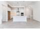 Modern kitchen features white cabinets, stainless steel appliances, and a spacious center island at 647 Spotted Falcon St, Las Vegas, NV 89138