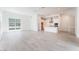 Bright living room with large windows and neutral tile flooring, adjacent to open kitchen at 647 Spotted Falcon St, Las Vegas, NV 89138