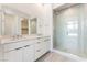 Bathroom with double sink vanity, a large mirror, and a glass enclosed shower at 647 Spotted Falcon St, Las Vegas, NV 89138