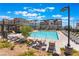 Enjoy the sunny community pool, surrounded by comfortable lounge chairs and landscaping at 647 Spotted Falcon St, Las Vegas, NV 89138