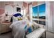 Bright bedroom with a large window view, stylish wallpaper, and modern decor at 654 Agate Bridge St, Las Vegas, NV 89138