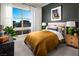 Cozy bedroom with a green accent wall, comfortable bed, and stylish decor creating a relaxing retreat at 654 Agate Bridge St, Las Vegas, NV 89138