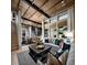 Bright living room with wood-beamed ceilings, a decorative coffee table, and an open floor plan leading to the kitchen at 654 Agate Bridge St, Las Vegas, NV 89138