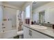 Bright bathroom showcasing a tiled shower, granite vanity, and ample shelving for storage at 6804 Sage Gold Ct, North Las Vegas, NV 89086