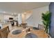 Cozy dining area features a wooden round table, seating for four, and easy access to the modern kitchen at 6804 Sage Gold Ct, North Las Vegas, NV 89086