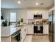 Well-equipped kitchen features stainless steel appliances, granite countertops, and an island with barstool seating at 6804 Sage Gold Ct, North Las Vegas, NV 89086