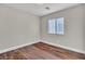 A bright bedroom featuring hardwood floors and a window allowing natural light at 7632 Calico Fields St, Las Vegas, NV 89149