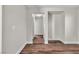 Hallway features wood-look flooring and access to multiple rooms at 7632 Calico Fields St, Las Vegas, NV 89149