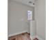 Neutral hallway featuring a small window and wood-look flooring at 7632 Calico Fields St, Las Vegas, NV 89149