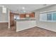 Modern kitchen featuring stainless steel appliances, granite countertops, and wood-look tile flooring at 7632 Calico Fields St, Las Vegas, NV 89149