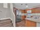 Kitchen showcasing stainless steel refrigerator, wood cabinets, and granite countertops at 7632 Calico Fields St, Las Vegas, NV 89149