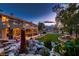 Stunning backyard with a luxurious outdoor kitchen, a mini golf course, and beautiful water features for relaxation and entertainment at 8396 Garnet Canyon Ln, Las Vegas, NV 89129