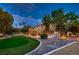 Expansive backyard featuring a well-manicured lawn, mature trees, and a charming outdoor seating area for enjoyable outdoor living at 8396 Garnet Canyon Ln, Las Vegas, NV 89129