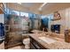 Modern bathroom featuring granite countertops, a glass-enclosed shower, and slate tile walls at 8396 Garnet Canyon Ln, Las Vegas, NV 89129