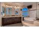 Spacious bathroom featuring a large soaking tub, double sinks and granite countertops at 8396 Garnet Canyon Ln, Las Vegas, NV 89129
