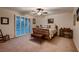 Bedroom with light carpet, a ceiling fan, and an abundance of natural light at 8396 Garnet Canyon Ln, Las Vegas, NV 89129