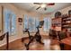 Bright exercise room with hardwood floors, modern exercise equipment, a ceiling fan and a convenient work desk at 8396 Garnet Canyon Ln, Las Vegas, NV 89129