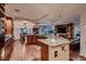 Spacious kitchen featuring granite counters, wood floors, island, and seamless open floorplan at 8396 Garnet Canyon Ln, Las Vegas, NV 89129