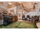 Grand living room boasting a soaring ceiling, elegant staircase, and a cozy golf simulator setup at 8396 Garnet Canyon Ln, Las Vegas, NV 89129