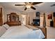 Spacious main bedroom features a four-poster bed, a fireplace, and a large dresser at 8396 Garnet Canyon Ln, Las Vegas, NV 89129