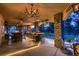 Luxurious outdoor kitchen with stone columns, built-in grill, bar seating, and decorative lighting at 8396 Garnet Canyon Ln, Las Vegas, NV 89129