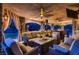 Outdoor patio with a fireplace, a kitchen area and comfortable seating at 8396 Garnet Canyon Ln, Las Vegas, NV 89129