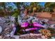 A beautiful, ornate pond features a playful collection of rocks, statues, and water plants at 8396 Garnet Canyon Ln, Las Vegas, NV 89129