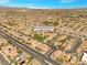 Expansive aerial view of the community, showcasing a lush park and well-planned streets at 8453 Cheerful Brook Ave, Las Vegas, NV 89143