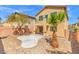 Back exterior of home featuring a balcony, patio, desert landscaping, and a small palm tree at 8453 Cheerful Brook Ave, Las Vegas, NV 89143