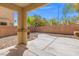 Exterior view of a backyard patio with columns, decorative rock and mature trees at 8453 Cheerful Brook Ave, Las Vegas, NV 89143