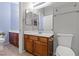 Bathroom featuring wood cabinets, dual mirrors, and modern fixtures at 8453 Cheerful Brook Ave, Las Vegas, NV 89143