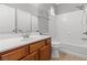 Bathroom with a white vanity, a bathtub and shower combination, and tiled walls at 8453 Cheerful Brook Ave, Las Vegas, NV 89143