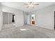 Expansive carpeted bedroom showcasing natural light, mirrored closet doors, and an attached bathroom at 8453 Cheerful Brook Ave, Las Vegas, NV 89143