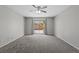 Spacious bedroom features carpet flooring, fan, and backyard access at 8453 Cheerful Brook Ave, Las Vegas, NV 89143
