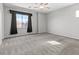 Spacious carpeted bedroom with a ceiling fan, large window, and dark curtains at 8453 Cheerful Brook Ave, Las Vegas, NV 89143
