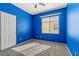 Bright bedroom with plush gray carpet, a ceiling fan, and a window bringing in natural light at 8453 Cheerful Brook Ave, Las Vegas, NV 89143