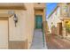 Close-up of the home's entrance with a classic green front door and well-lit entry at 8453 Cheerful Brook Ave, Las Vegas, NV 89143