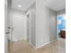 Neutral hallway features tile flooring and access to the garage and bathroom at 8453 Cheerful Brook Ave, Las Vegas, NV 89143