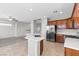 Open kitchen layout with a center island, stainless steel appliances, and seamless flow to the living area at 8453 Cheerful Brook Ave, Las Vegas, NV 89143