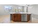 Kitchen island featuring a sink, dishwasher, and plenty of countertop space, adjacent to a dining area at 8453 Cheerful Brook Ave, Las Vegas, NV 89143