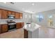 Well-lit kitchen featuring an island with a sink and modern appliances including a microwave, range, and oven at 8453 Cheerful Brook Ave, Las Vegas, NV 89143