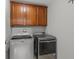 Laundry room features cabinets and Maytag washer and dryer at 8453 Cheerful Brook Ave, Las Vegas, NV 89143